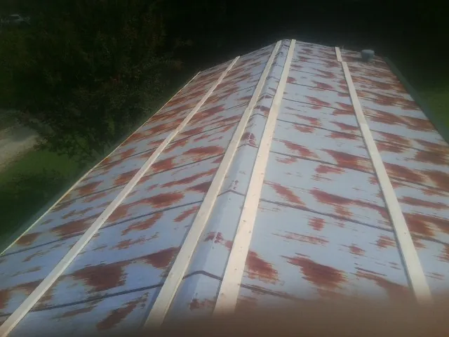 Rusted metal roof panels with new wood purlins before replacement — Storm Damage Roof Repair in Pleasant Prairie by Roofing Brothers