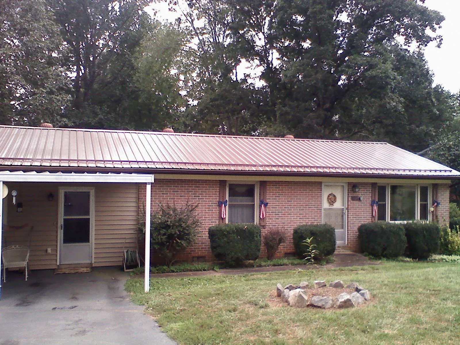 Bronze metal roof and carport on a brick ranch home — Roof Repair work by our crew in Pleasant Prairie